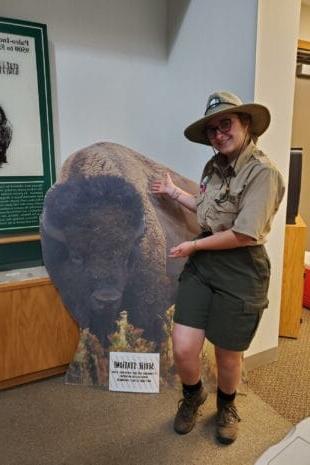 semesters studying in historic structures and cozy W&J senior Stephanie Shugerman poses with cardboard buffalo in park ranger uniform.